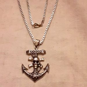 Silver necklace with an anchor and skull